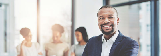 African-american male business partner smiling in his corporate office